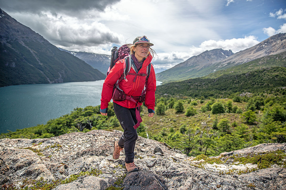 Hiking above lake on rock (Osprey Aura AG LT 65 women's backpacking pack)